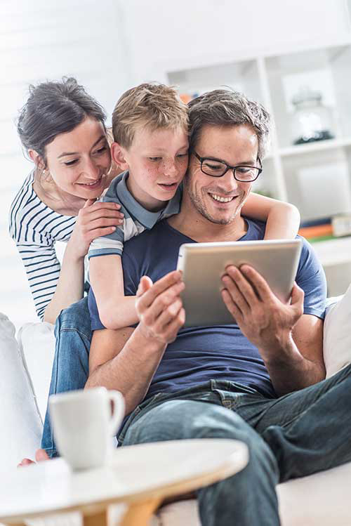 Family looking a tablet